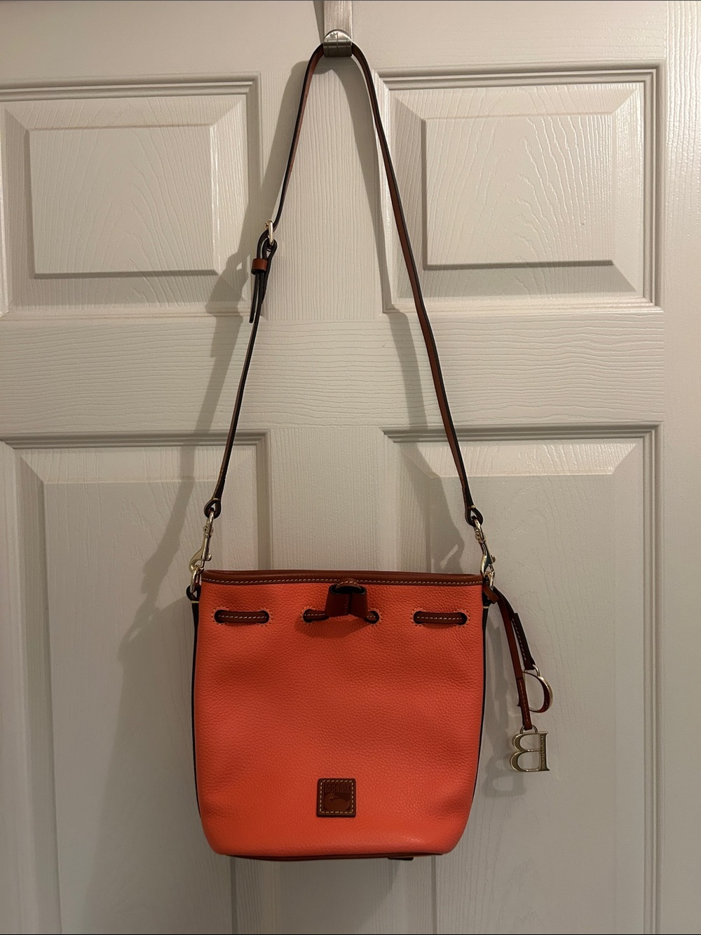 Dooney & Bourke Orange Pebble Leather Crossbody Bucket Bag with Gold Hardware